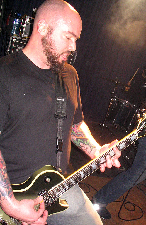 a man playing guitar in a recording studio