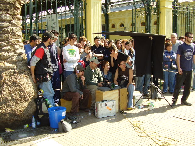 a group of people gathered around and one person holding a small case