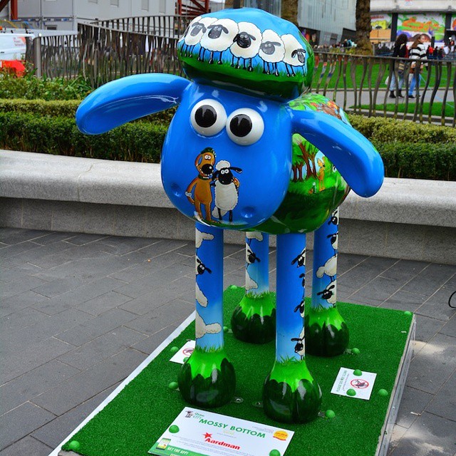 a blue dog statue that has its eyes wide open