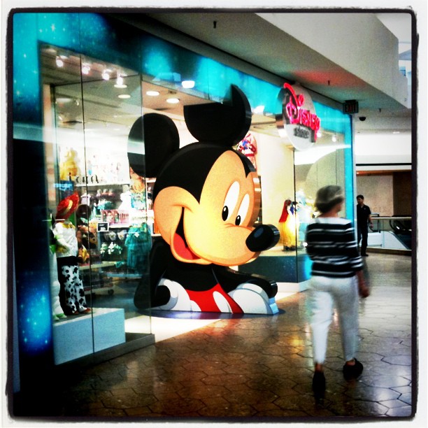a large stuffed mouse in a store window