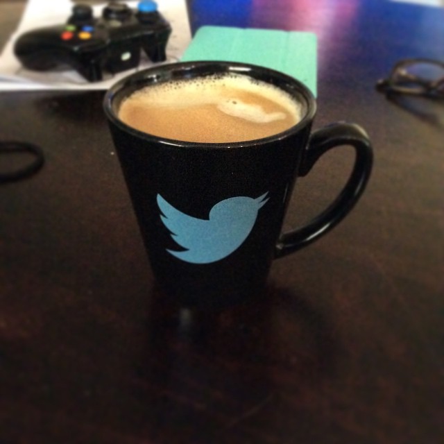 a mug with a blue twitter symbol on it