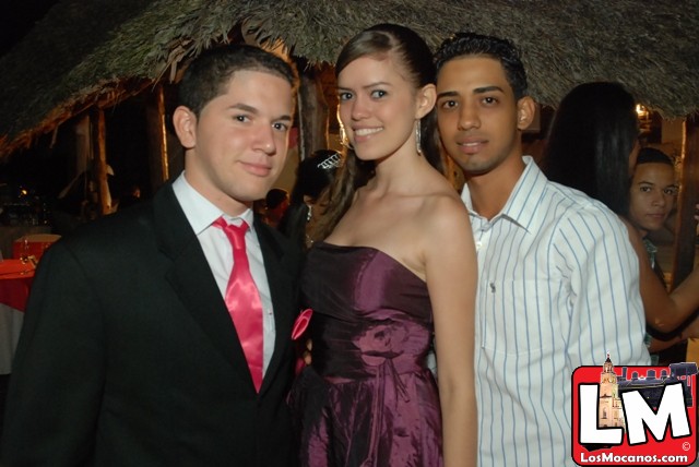 three people posing for a po at a formal event