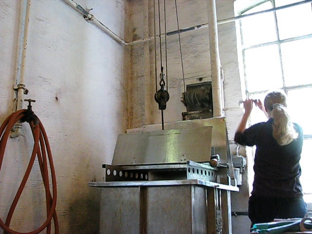 a man in a factory checking soing on the back wall