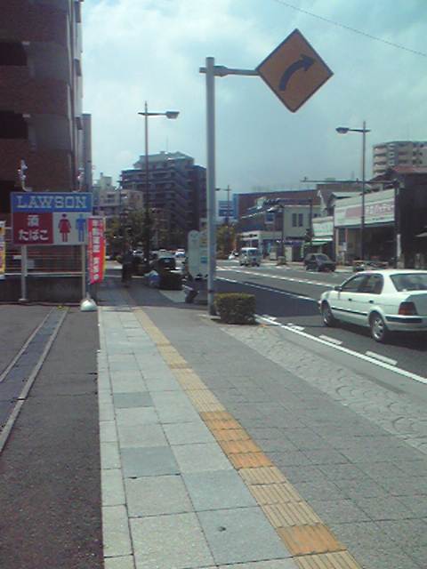 a city street with cars parked on either side of the street