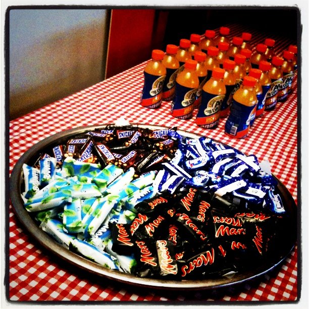 a table is set up with bottles and snacks