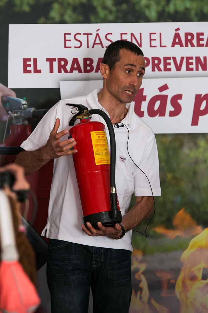 a man holding a fire extinguisher in his hands