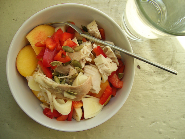 there is a bowl of food with fruits and meats