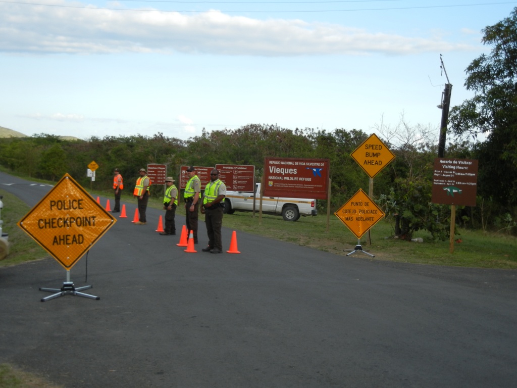 a group of construction workers in neon green vests are standing at a street