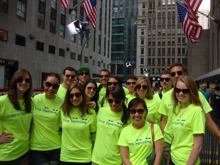 a group of young people posing in front of some buildings