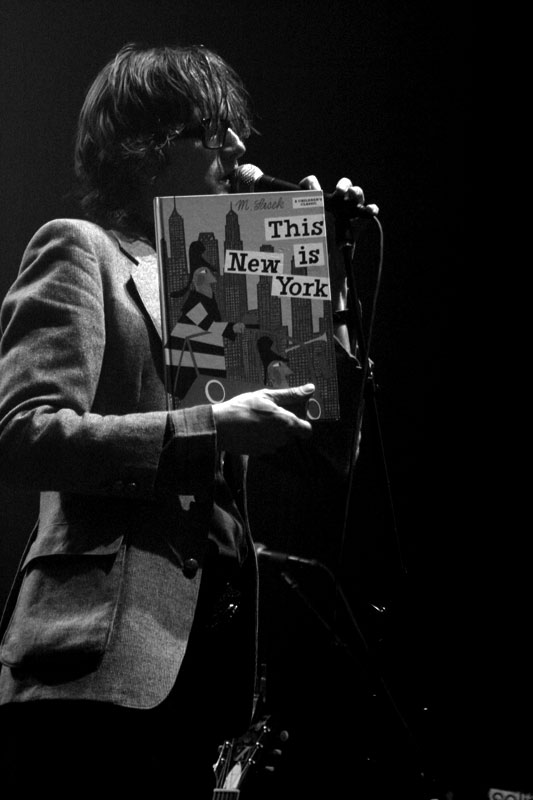 a woman holding a sign with the words this new york