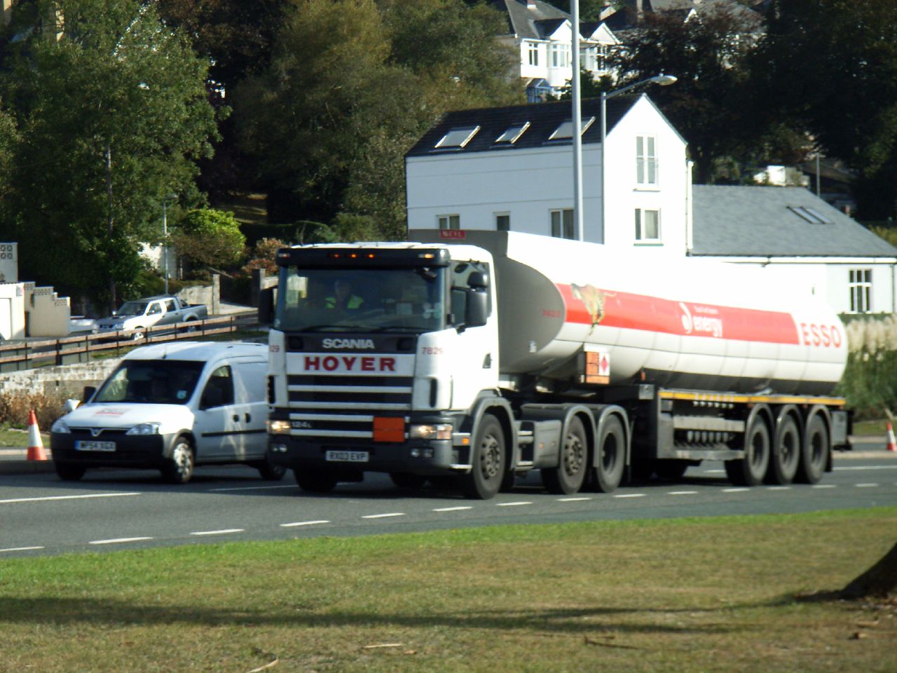 a white truck and a white van on a street