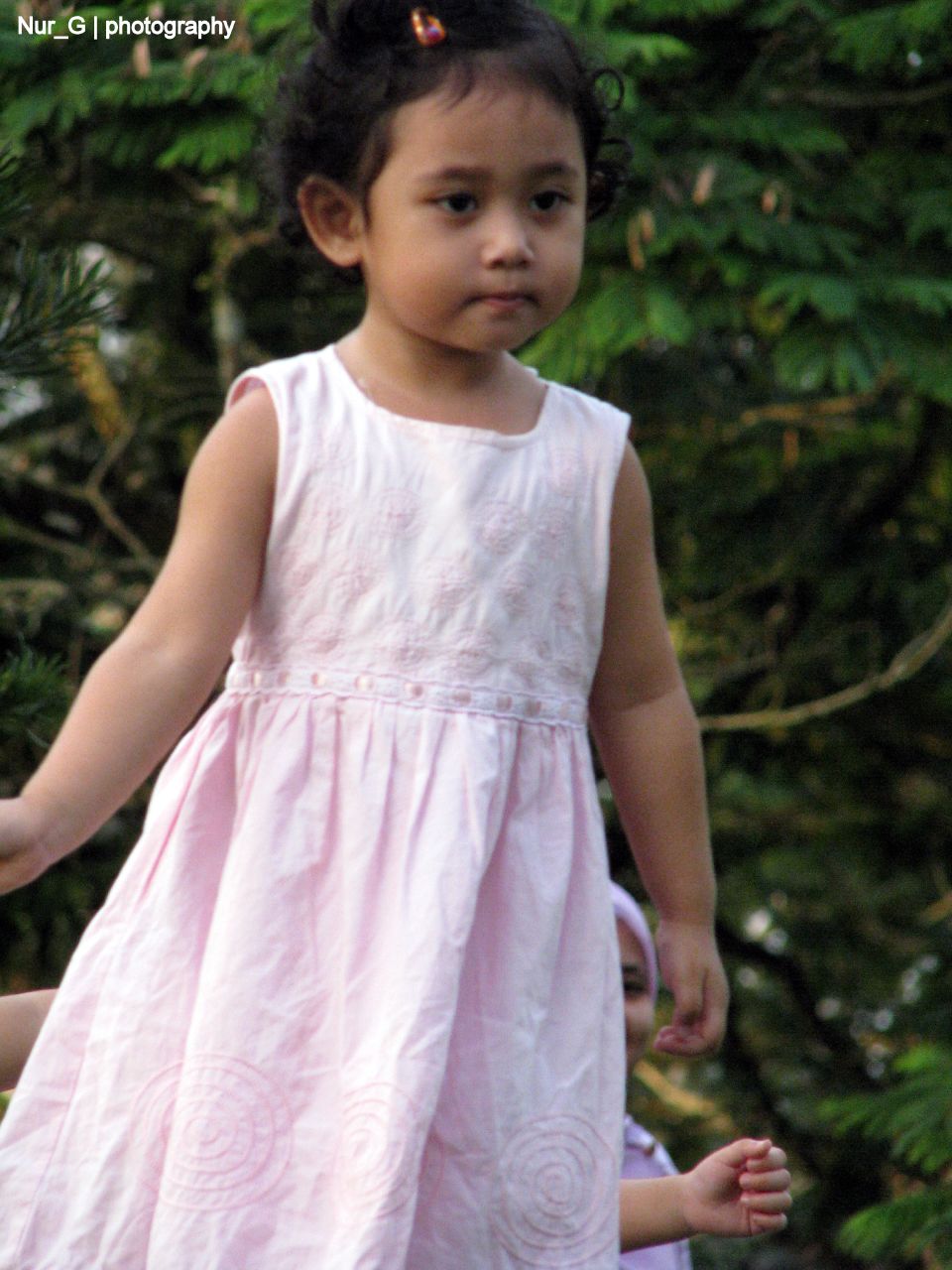 small child walking towards camera with a frisbee in her hand