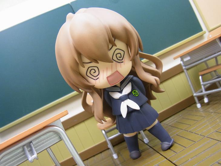 a small doll is standing in a class room
