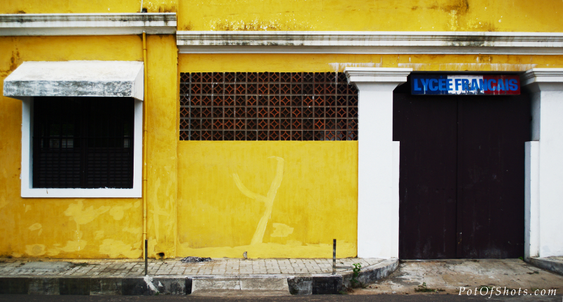 two doors on a yellow building, one is dark