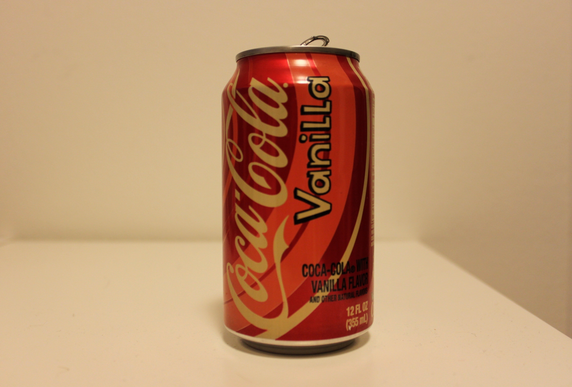 a can of coca - cola sitting on a table