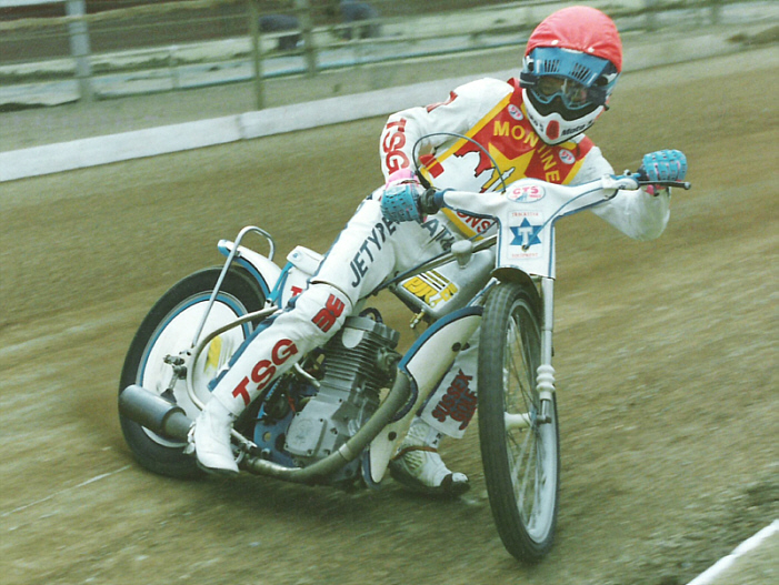a person in helmet and white suit on motorcycle