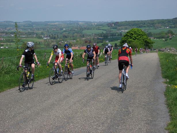 a group of bikers ride down a road together