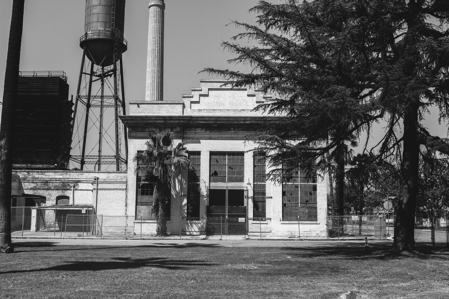 a building with towers next to some trees and other buildings