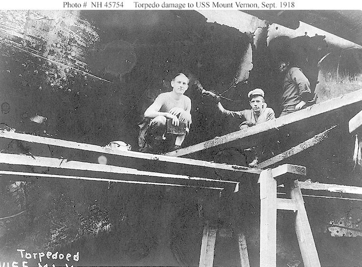 two boys are standing on the bottom of a structure
