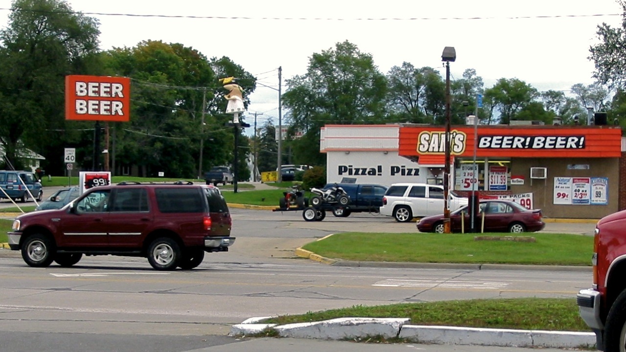 two red trucks that are parked in the street