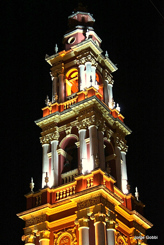 the clock is clearly visible in this tower at night