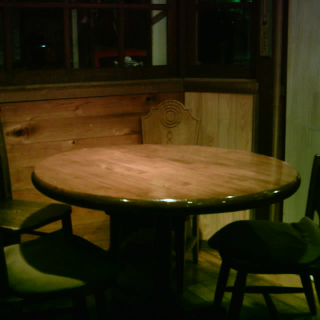 table and chairs next to a bench in a kitchen