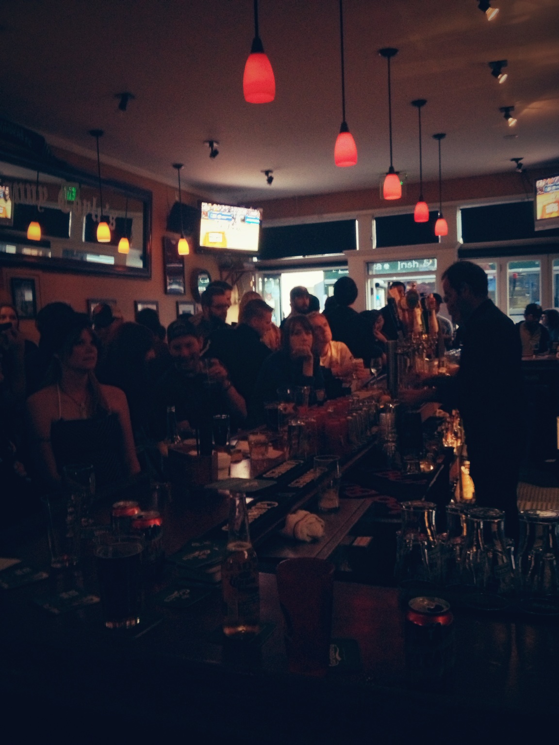 a group of people are gathering at the bar