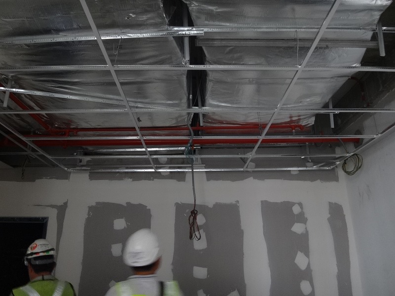 workers are working on a suspended metal roof