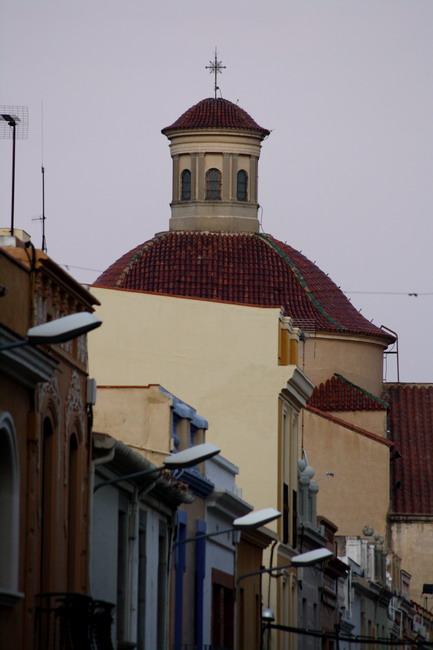 a clock tower in the distance behind buildings