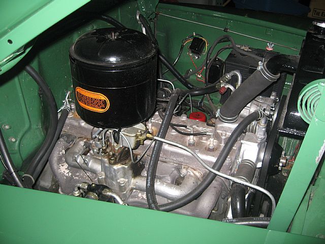 a small engine in a car with hoses connected