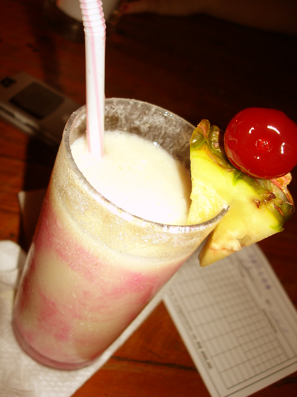 a very tasty looking drink with a cherry and a slice of pineapple