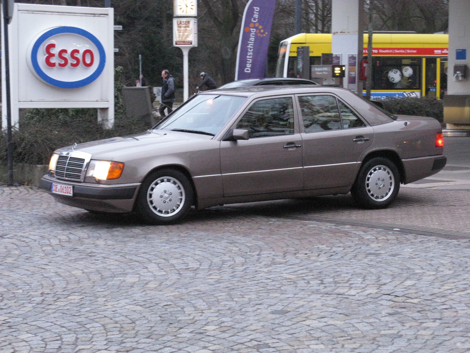 a gray car parked next to a building