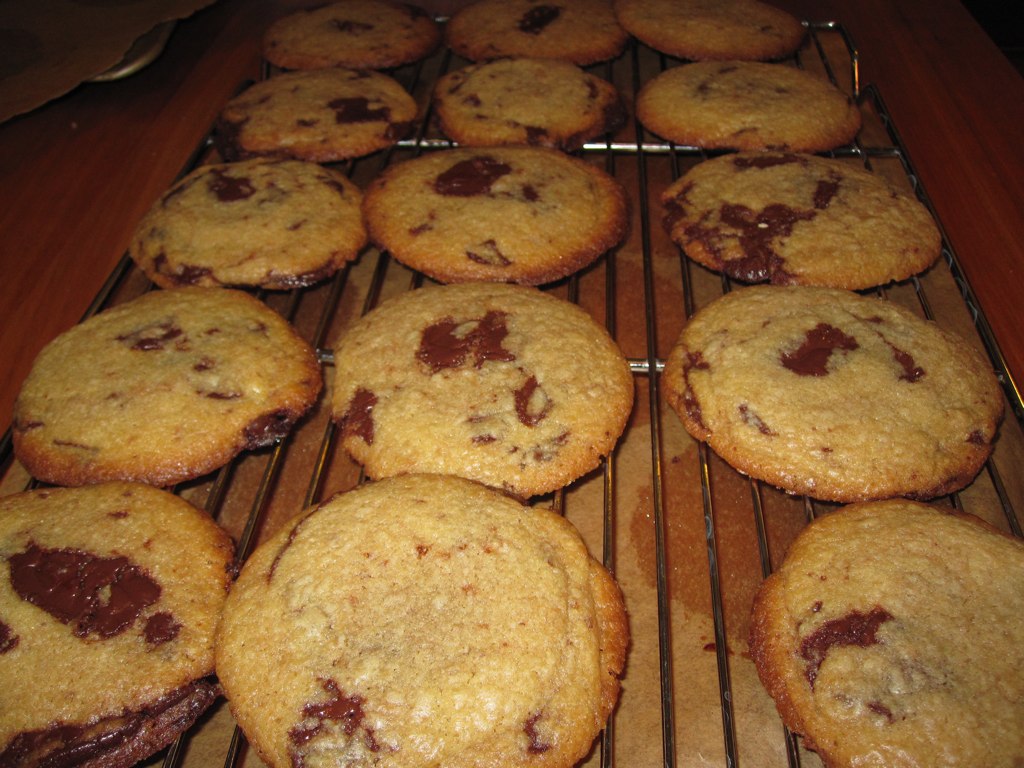 cookies cooling on a wire rack lined up on top of a table