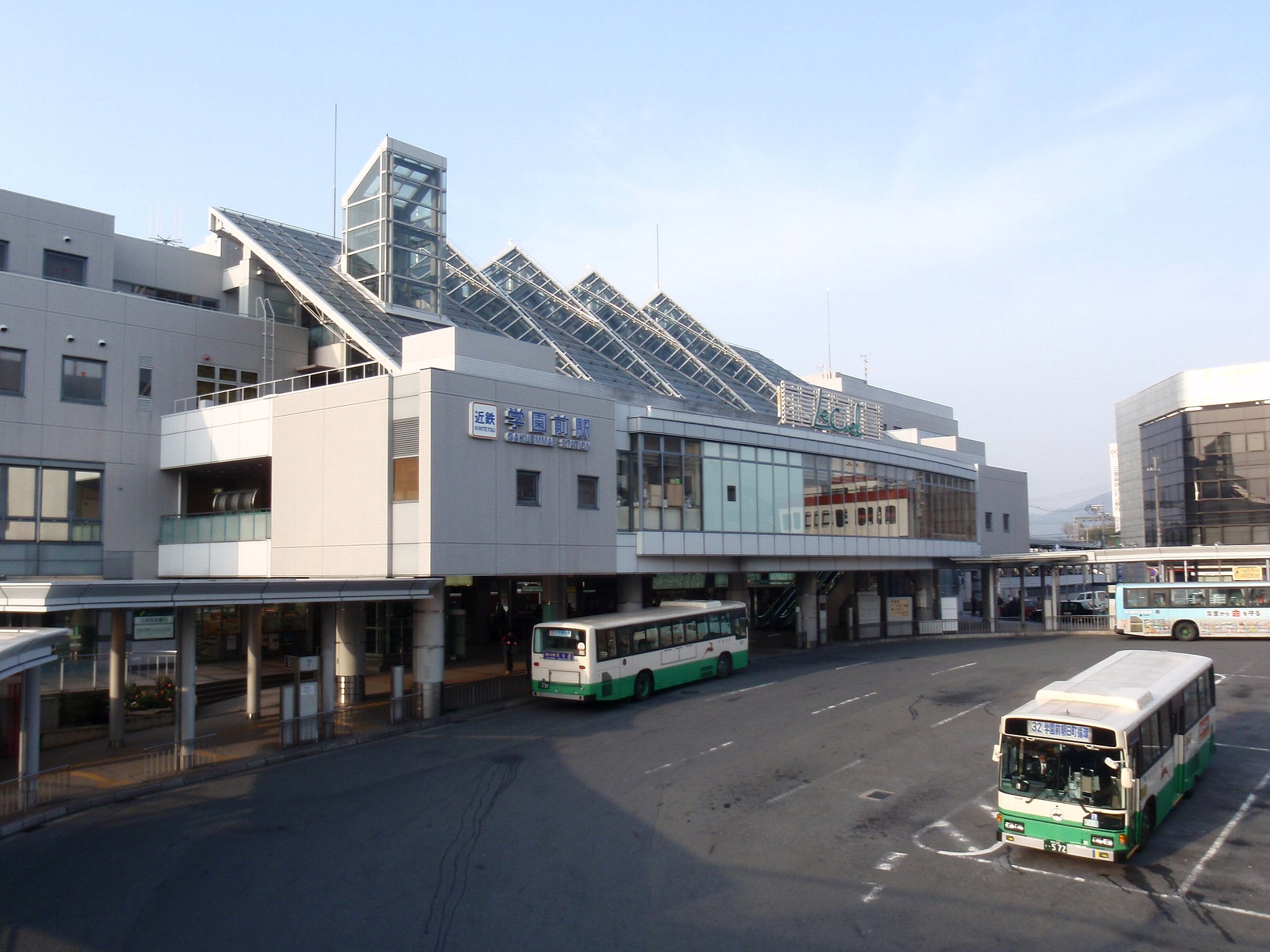 buses parked near the terminal at an airport