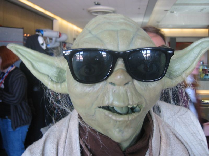 a star wars yoda is wearing a sweater, sunglasses and cardigan