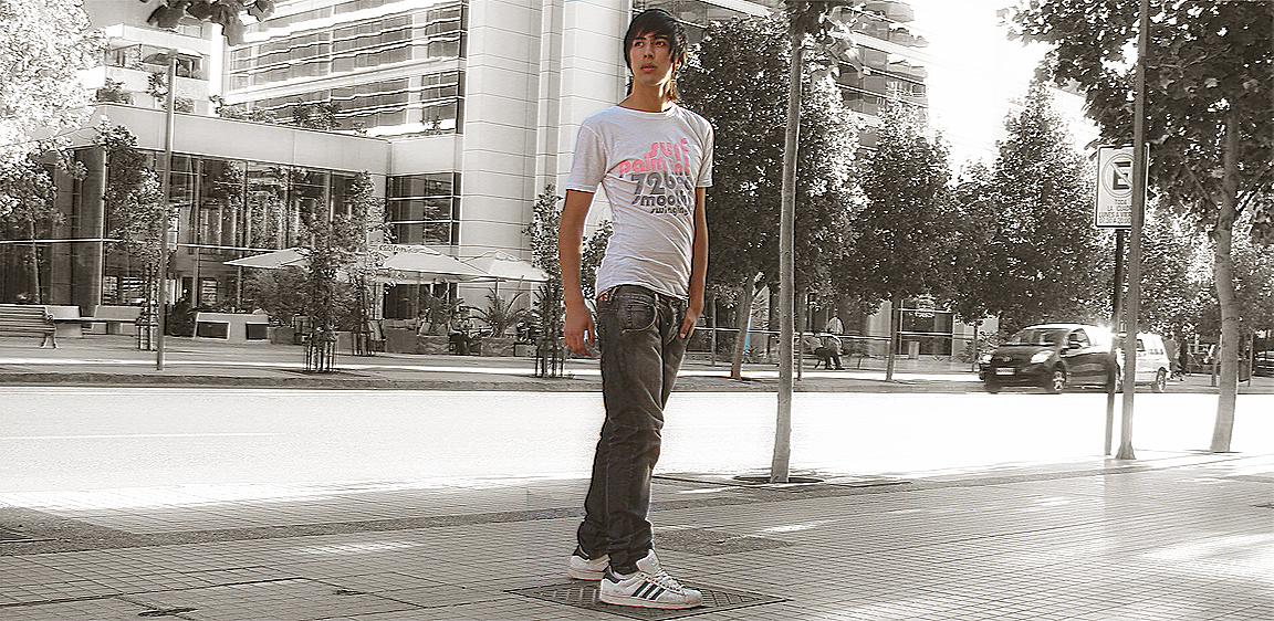a man standing in the middle of a city with his skateboard in hand