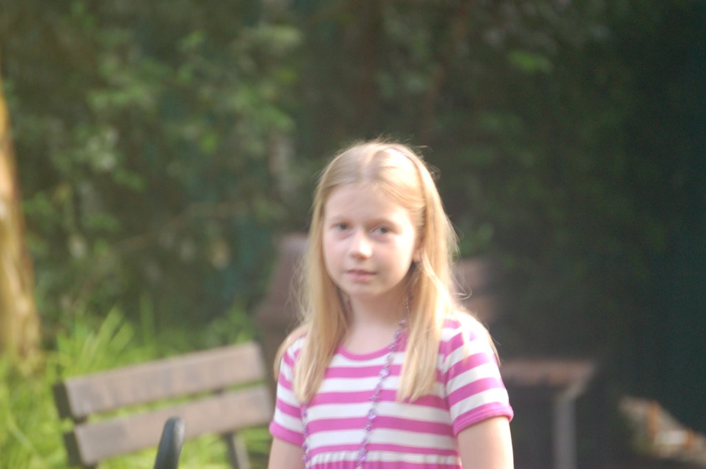 a  standing next to a bench in the grass