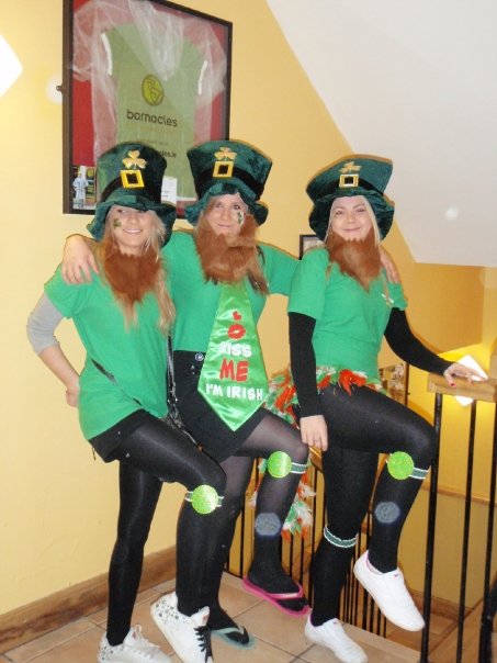 three people in green irish outfits and wigs