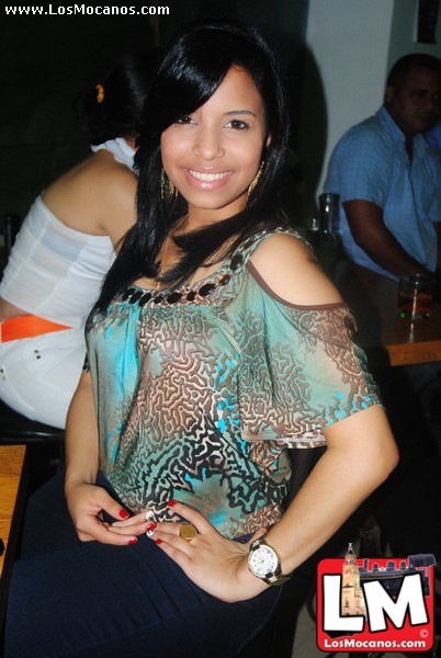 an asian woman posing for the camera at a party