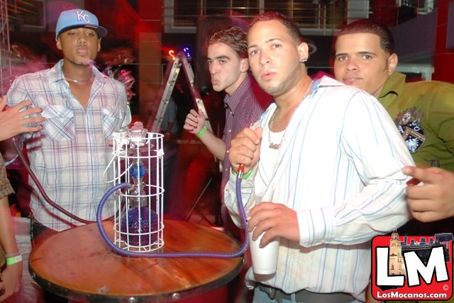 a group of men standing around a wine cooler