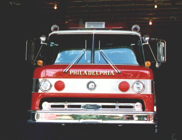 a red and white fire truck sitting in a garage
