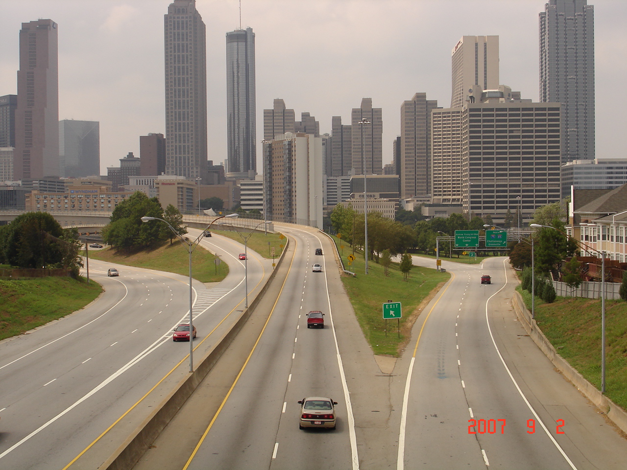 a city skyline behind an interstate highway with skyscrs