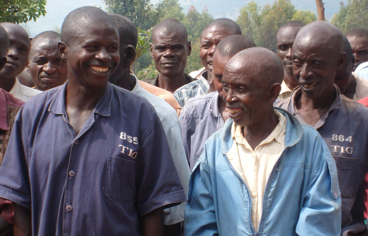 a group of men standing next to each other in a parking lot