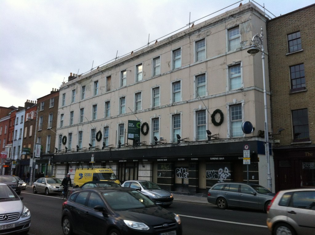 a street scene with traffic and building