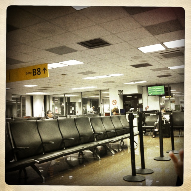 an empty airplane baggage claim area with some black and white lines