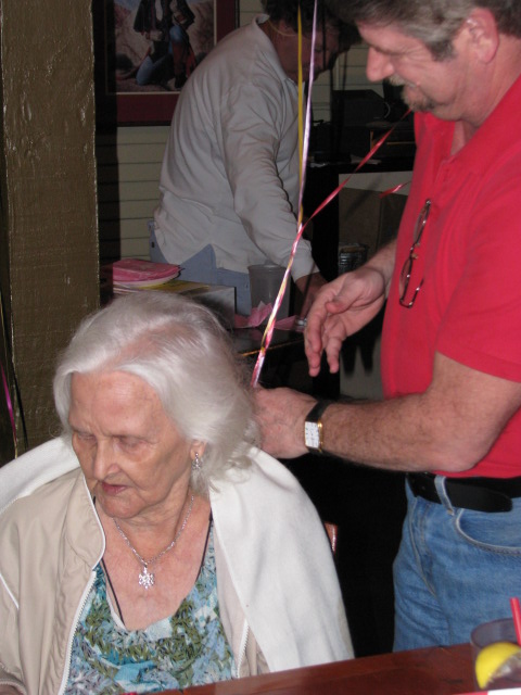 a woman  a ribbon with another person in red shirt