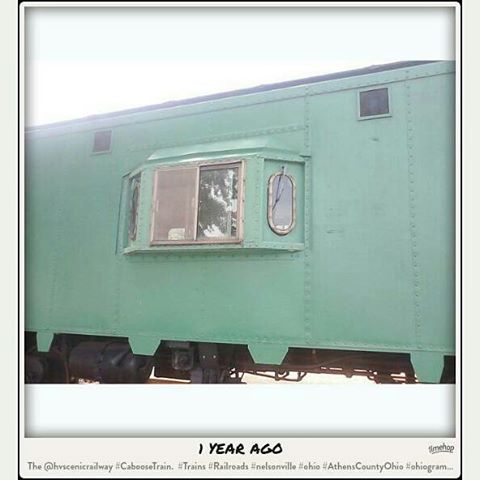 the side of a green train car, looking out the window