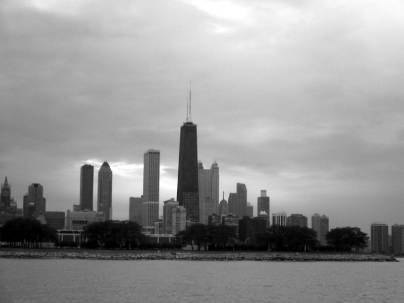 a city skyline with tall buildings overlooking the water