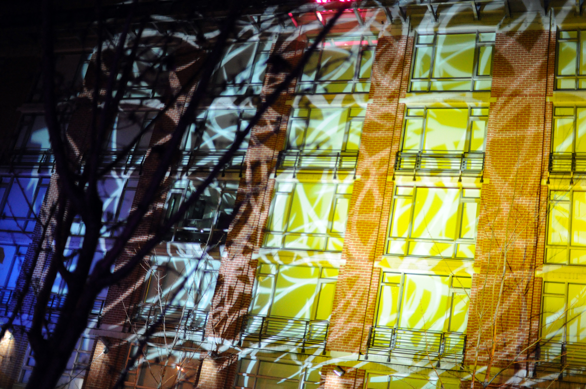 an artistic wall display next to trees and buildings