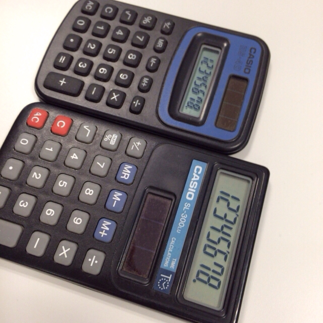 two calculators that are sitting on a table